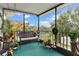 Spacious screened porch with wicker furniture and tranquil wooded views at 1399 Old Mount Dora Rd, Eustis, FL 32726