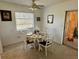 Bright dining area features a round table set for four, with natural light and a view to the outside patio at 1456 N Page Dr, Deltona, FL 32725