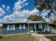Charming single-story home featuring a metal roof, freshly painted exterior, and well-maintained yard at 1456 N Page Dr, Deltona, FL 32725