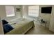 Simple main bedroom with terrazzo flooring, two windows, and a wall-mounted television at 1456 N Page Dr, Deltona, FL 32725