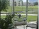 Screened patio with outdoor furniture and community view at 2302 Butterfly Palm Way # 105, Kissimmee, FL 34747