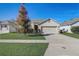One-story house with a two-car garage and well-manicured lawn at 273 St Georges Cir, Eagle Lake, FL 33839