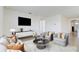 Bright living room featuring comfortable seating and a large TV at 273 St Georges Cir, Eagle Lake, FL 33839