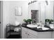 Clean bathroom with dark countertop, white cabinets, and large mirror at 2821 Almaton Loop # 101, Kissimmee, FL 34747