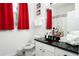 Clean bathroom with red curtains, Mickey Mouse decor, and dark countertop at 2821 Almaton Loop # 101, Kissimmee, FL 34747