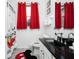 Clean bathroom with red curtains, Mickey Mouse decor, and dark countertop at 2821 Almaton Loop # 101, Kissimmee, FL 34747
