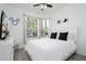 Bedroom with white queen-size bed and large window at 2821 Almaton Loop # 101, Kissimmee, FL 34747
