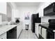 Modern kitchen with white cabinets and black appliances at 2821 Almaton Loop # 101, Kissimmee, FL 34747