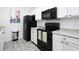 Modern kitchen with white cabinets and black appliances at 2821 Almaton Loop # 101, Kissimmee, FL 34747