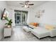 Living room with white sectional sofa, sliding door to patio, and TV at 2821 Almaton Loop # 101, Kissimmee, FL 34747