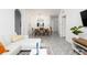 Open living room with white sectional sofa and view of dining area at 2821 Almaton Loop # 101, Kissimmee, FL 34747
