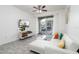 Living room with white sectional sofa, sliding door to patio, and TV at 2821 Almaton Loop # 101, Kissimmee, FL 34747