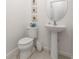 Clean, simple bathroom with pedestal sink, toilet, and mirror at 285 Miro Dr, Davenport, FL 33837