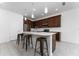 Modern kitchen with dark brown cabinets, white countertops, and stainless steel appliances at 285 Miro Dr, Davenport, FL 33837