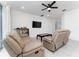 Living room featuring two reclining sofas and a coffee table at 285 Miro Dr, Davenport, FL 33837