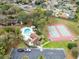 Aerial of community pool and tennis courts amidst lush greenery; includes convenient parking and nearby residences at 4008 Crossroads Pl, Casselberry, FL 32707