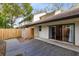 Private back patio with a wooden deck perfect for outdoor relaxation and entertaining with sliding door access to the home at 4008 Crossroads Pl, Casselberry, FL 32707