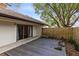 Back patio featuring a wooden deck surrounded by a privacy fence, offering a serene outdoor space with a sliding door at 4008 Crossroads Pl, Casselberry, FL 32707