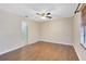 Spacious bedroom with wood floors, ceiling fan, and natural light from the window at 4008 Crossroads Pl, Casselberry, FL 32707