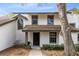 Charming two-story home featuring a covered entryway and lush landscaping at 4008 Crossroads Pl, Casselberry, FL 32707