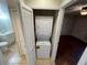 Convenient laundry closet with stacked washer and dryer, adjacent to a bathroom and featuring easy access from the hall at 4008 Crossroads Pl, Casselberry, FL 32707