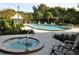 Community pool area features a hot tub and lounge seating, perfect for relaxation and recreation at 4008 Crossroads Pl, Casselberry, FL 32707