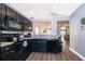 Open kitchen with dark cabinets and view of dining area at 510 Canary Island Cir, Davenport, FL 33837