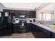 Modern kitchen featuring black cabinets and granite countertops at 510 Canary Island Cir, Davenport, FL 33837