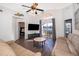 Living room features leather sofas, large TV, and pool view at 510 Canary Island Cir, Davenport, FL 33837