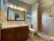 Bathroom with shower, toilet, vanity, and wood cabinet at 536 Palm Dr, Winter Garden, FL 34787