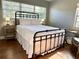 Bedroom featuring a metal bed frame and wood floors at 536 Palm Dr, Winter Garden, FL 34787