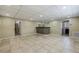 Spacious basement recreation room with wet bar, tiled floors, and plenty of room for entertainment at 604 Endsley Ave, Altamonte Springs, FL 32701