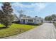 Gray house with walkway, manicured lawn, and paver driveway at 604 Endsley Ave, Altamonte Springs, FL 32701