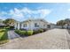 Gray house with manicured lawn and paver driveway at 604 Endsley Ave, Altamonte Springs, FL 32701
