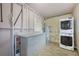 Convenient laundry room with stackable washer and dryer, and ample cabinet space at 604 Endsley Ave, Altamonte Springs, FL 32701