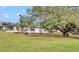 Landscaped backyard showcasing a renovated home and tranquil setting at 6424 Sleepy Hollow Dr, Orlando, FL 32810