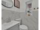 Clean bathroom with marble tile, a white vanity, and a toilet at 6424 Sleepy Hollow Dr, Orlando, FL 32810