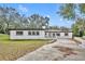 White single story home with a large yard and driveway at 6424 Sleepy Hollow Dr, Orlando, FL 32810
