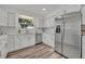 Modern white kitchen with stainless steel appliances at 6424 Sleepy Hollow Dr, Orlando, FL 32810