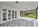 Covered patio with view of lake. Features modern tile flooring at 6424 Sleepy Hollow Dr, Orlando, FL 32810