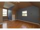 A bedroom with hardwood floors, two windows, and blue and brown accent walls at 712 Grandview Ave, Altamonte Springs, FL 32701