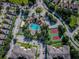 Aerial view showing community pool, tennis courts, and buildings at 8103 Coconut Palm Way # 105, Kissimmee, FL 34747