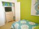 Bedroom with twin beds, dresser, and closet at 8103 Coconut Palm Way # 105, Kissimmee, FL 34747