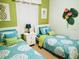 Twin bedroom with bright walls and matching bedding at 8103 Coconut Palm Way # 105, Kissimmee, FL 34747