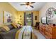 Bedroom with king-size bed, dresser, and ceiling fan at 8103 Coconut Palm Way # 105, Kissimmee, FL 34747