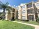 Exterior view of condo building showcasing landscaping and walkways at 8103 Coconut Palm Way # 105, Kissimmee, FL 34747