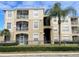 Condo building exterior with balconies and landscaping at 8103 Coconut Palm Way # 105, Kissimmee, FL 34747