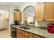 Kitchen with granite countertops and pass-through to dining area at 8103 Coconut Palm Way # 105, Kissimmee, FL 34747