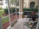 Screened porch overlooking backyard with table and chairs at 8103 Coconut Palm Way # 105, Kissimmee, FL 34747