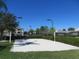 Sand volleyball court with surrounding hedges and lights at 8103 Coconut Palm Way # 105, Kissimmee, FL 34747